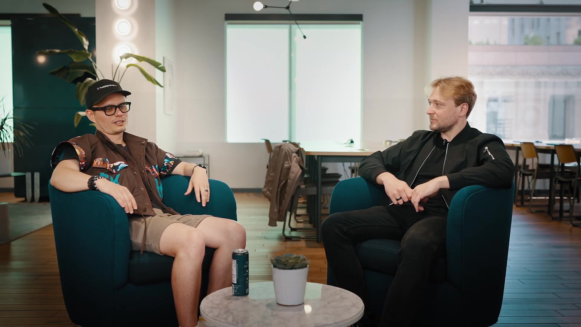 Francisk Hanchar and Happyverse founder Max Sapo in teal armchairs during The Bay Signal podcast recording on Montgomery Street, San Francisco