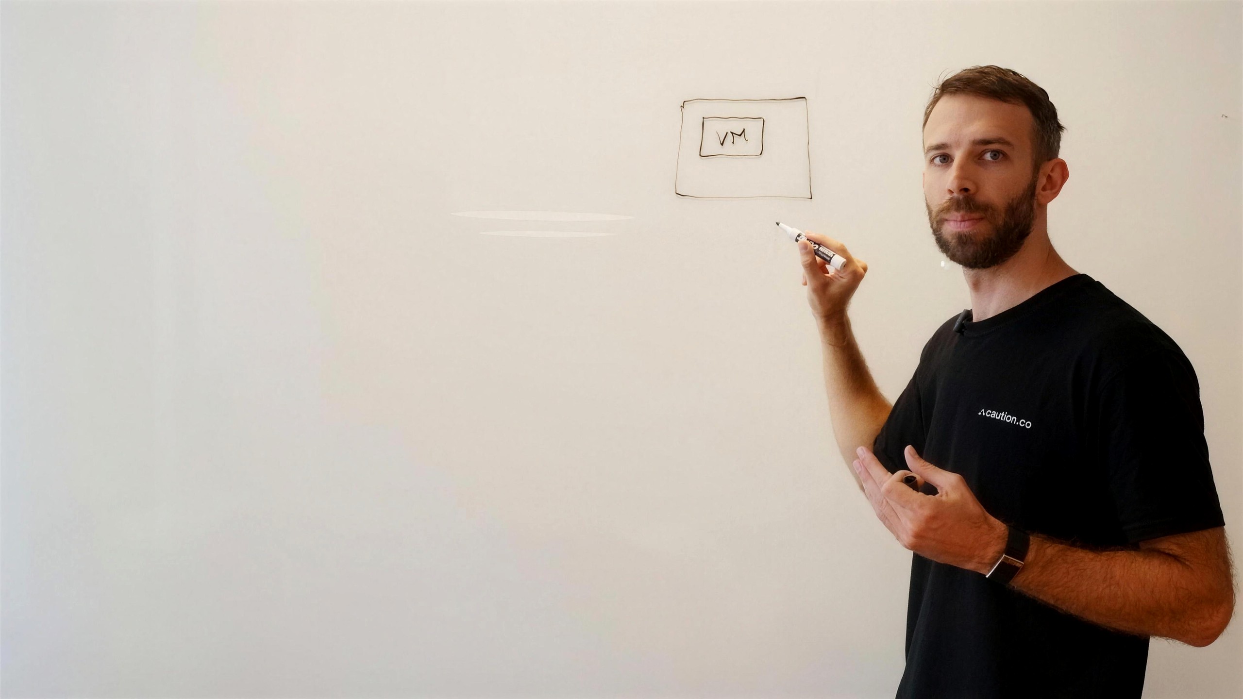 Caution CEO Anton Livaja explaining confidential compute at a whiteboard in FogLine Visuals' SoMa studio, San Francisco