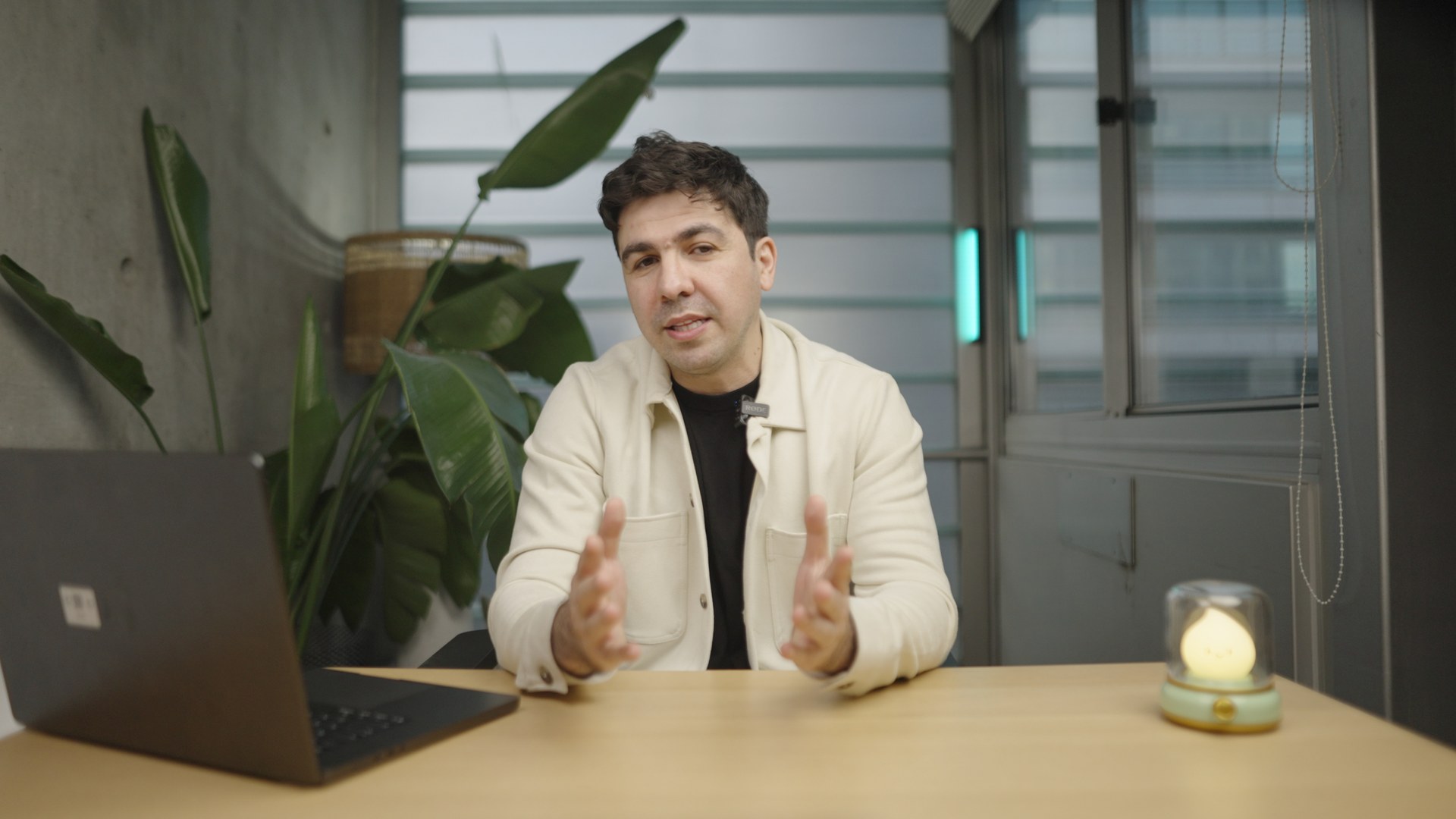 SUN co-founder and CEO Artin Bogdanov recording a launch announcement at a desk set with a practical lamp in FogLine Visuals' SoMa studio, San Francisco