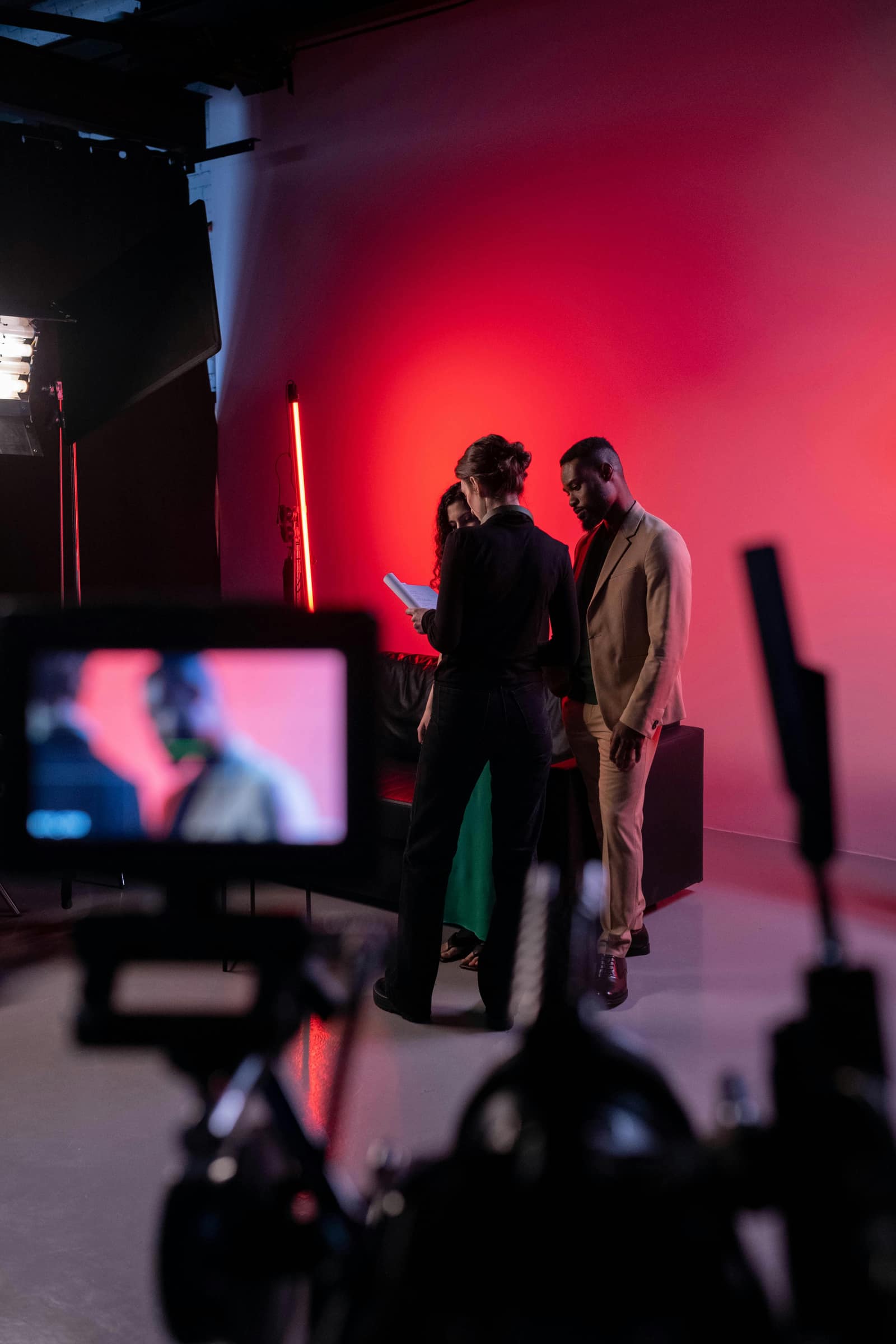 FogLine Visuals crew directing talent on a magenta-lit studio set