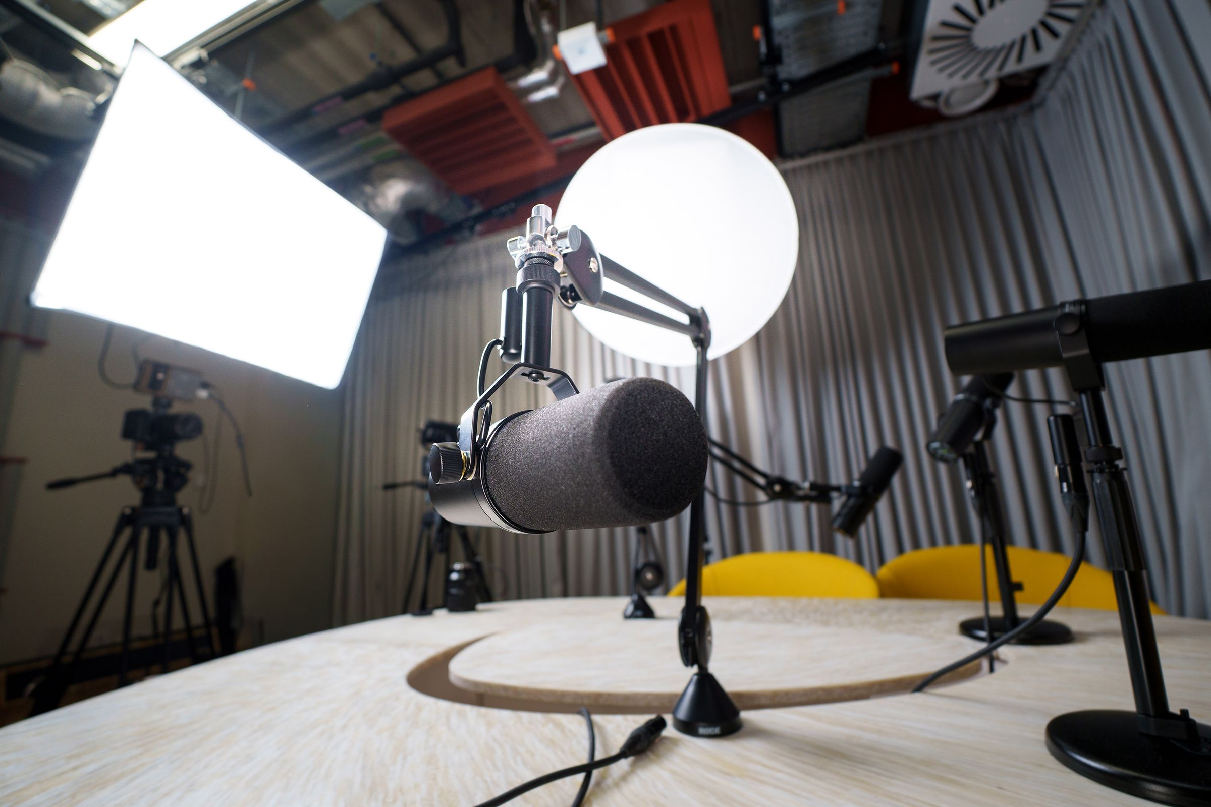 Podcast studio with softbox lighting and boom microphones