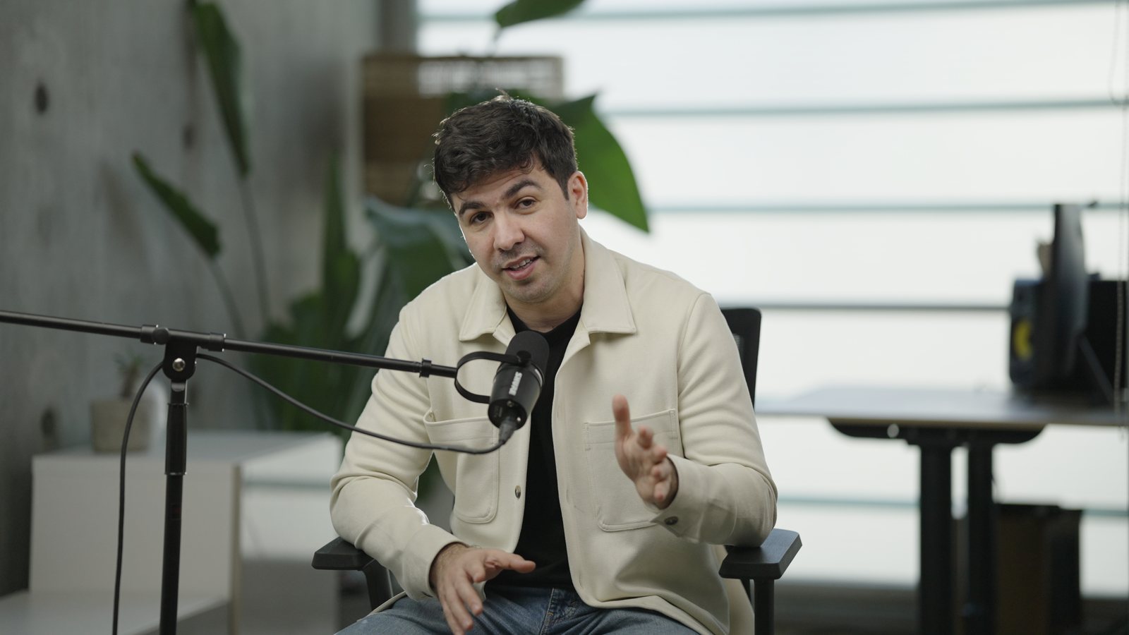 Artin Bogdanov, CEO of SUN, seated interview with a boom mic, daylight, filmed by FogLine Visuals at its SoMa studio in San Francisco