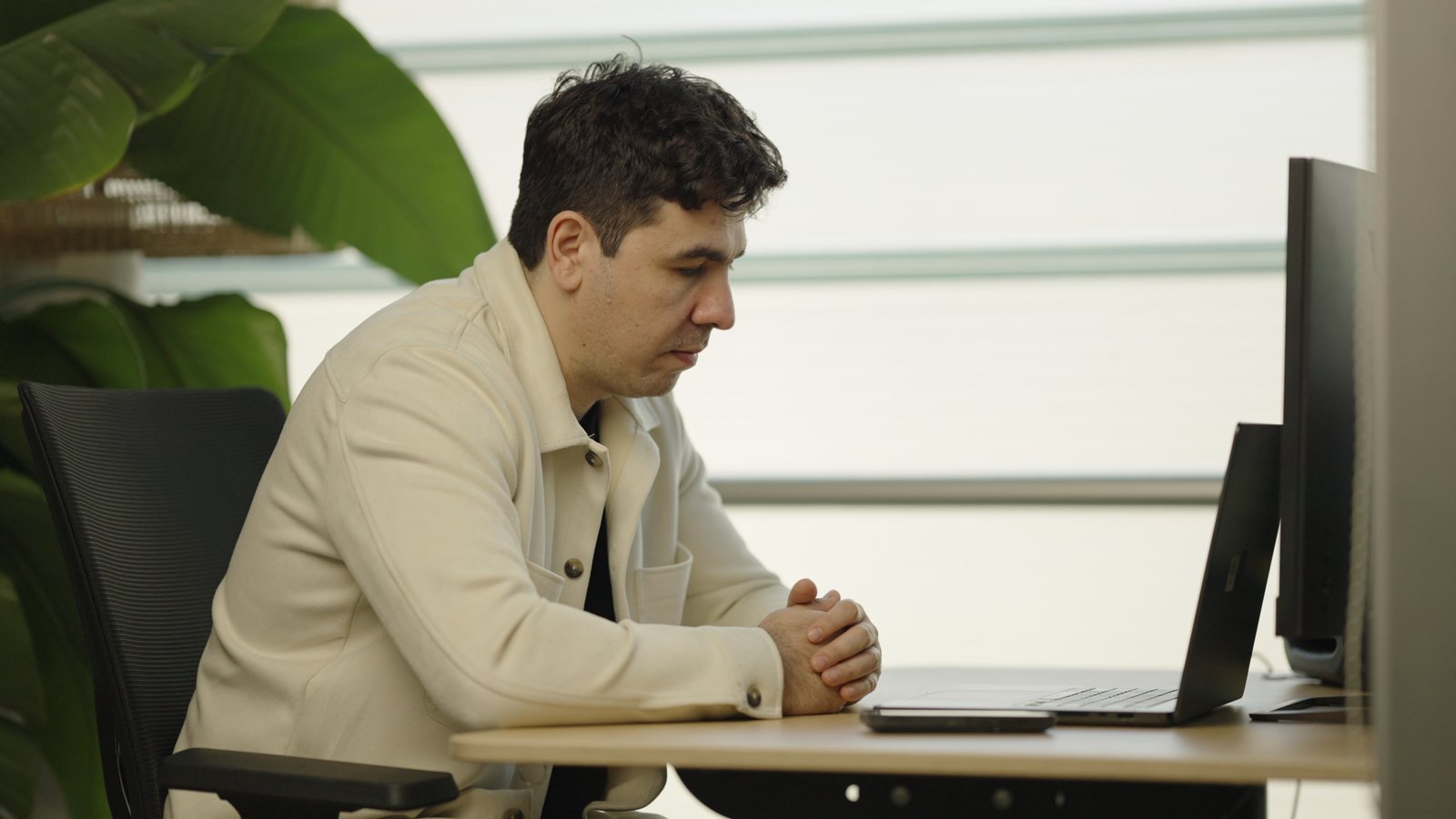 Artin Bogdanov, CEO of SUN, side angle at the work desk, filmed by FogLine Visuals at its SoMa studio in San Francisco