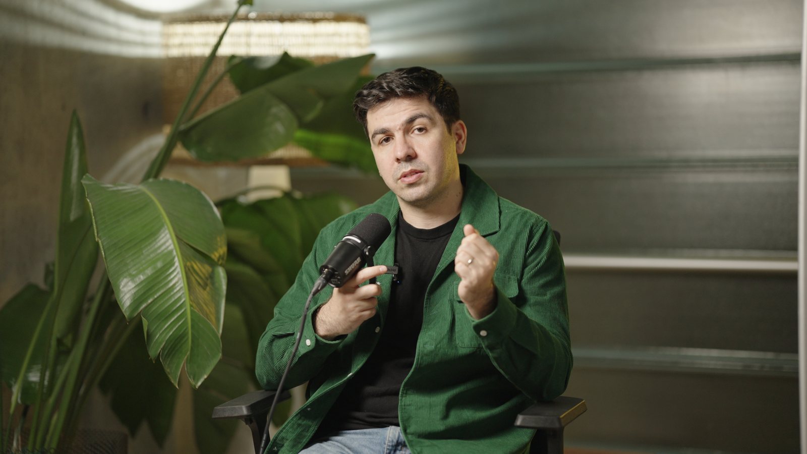 Artin Bogdanov, CEO of SUN, handheld mic, warm side light, filmed by FogLine Visuals at its SoMa studio in San Francisco