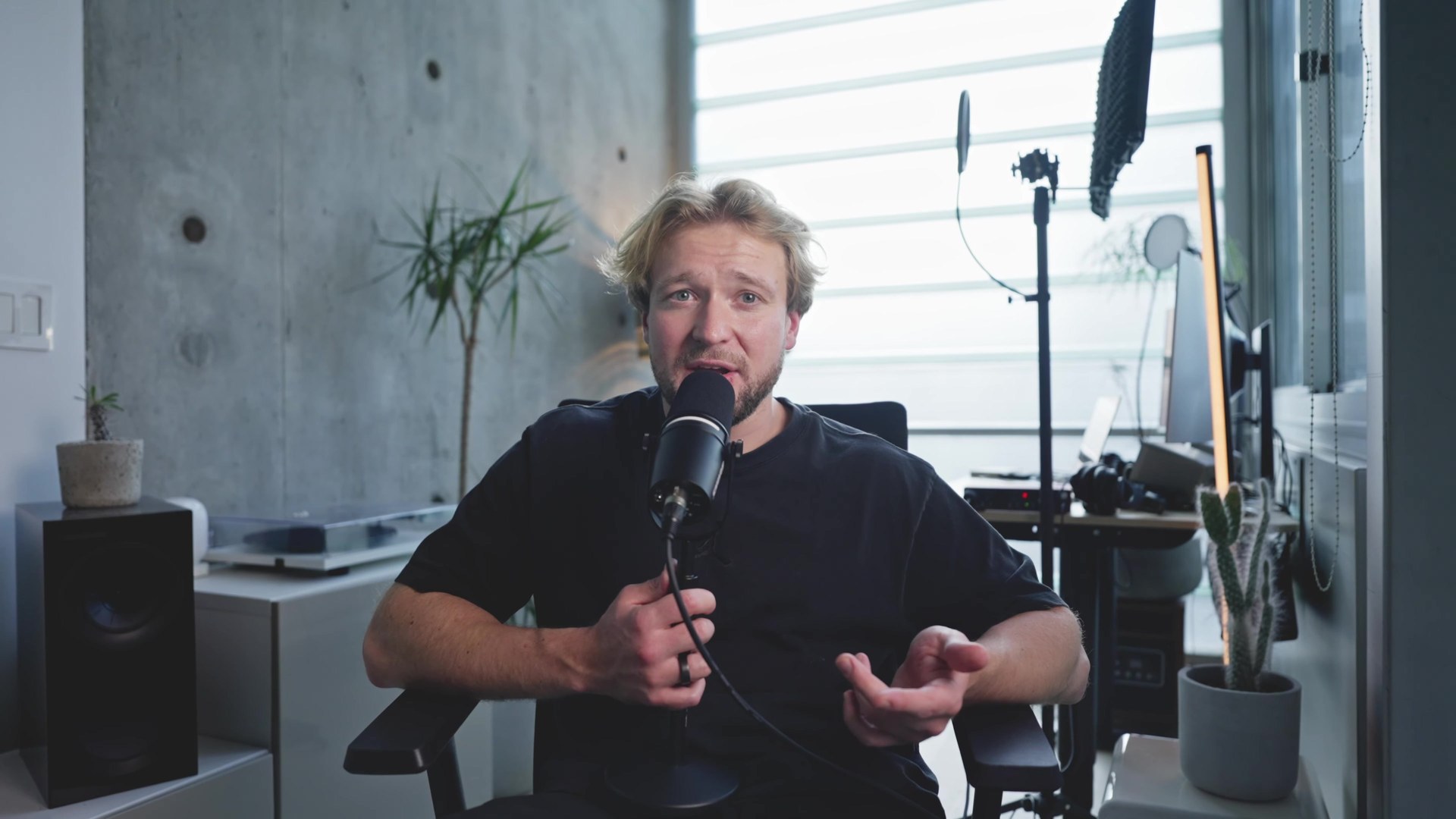Daytime setup in the FogLine studio: concrete wall, window light and a podcast microphone